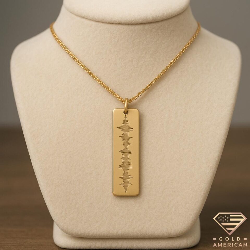 Gold rectangle bar necklace engraved with custom sound wave on a delicate rope chain