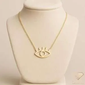 Minimalist gold evil eye pendant necklace with lashes on a delicate chain