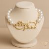 Custom gold name bracelet with pearl beads featuring engraved “Alexa James” design — personalized luxury jewelry.