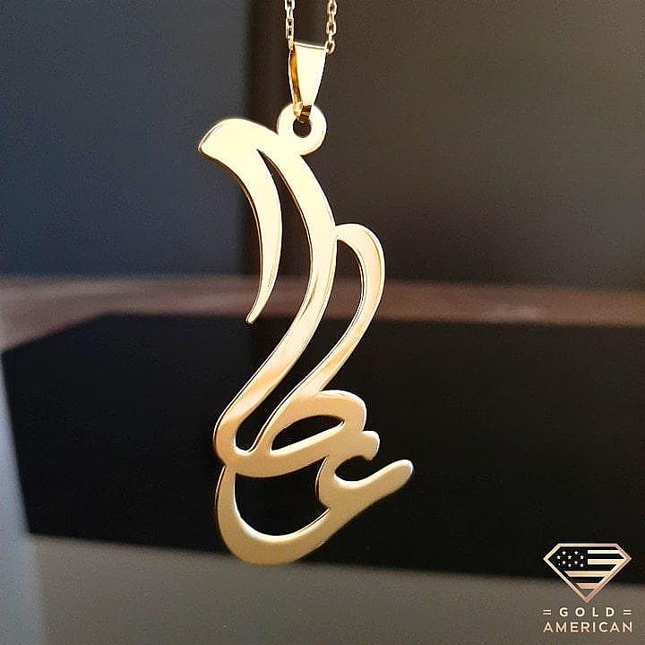 Custom Arabic Calligraphy Gold Pendant on a black display