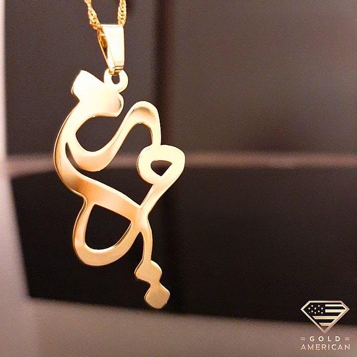 Gold Arabic Name Necklace on a black display