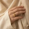Artistic Gold Ring with Paisley Charm on Hand