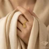 Artistic Gold Ring with Paisley Charm on Hand Close up