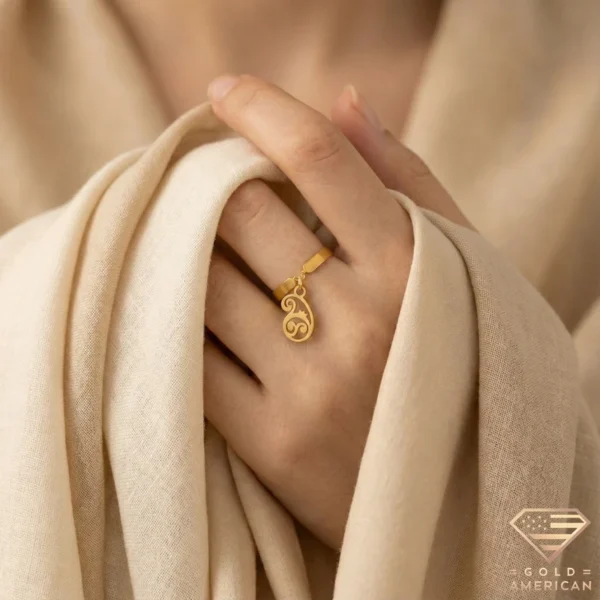 Artistic Gold Ring with Paisley Charm on Hand Close up